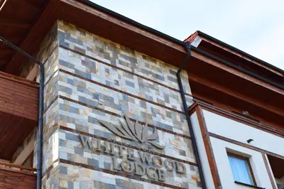 a sign on the side of a building at White Wood Lodge in Bansko