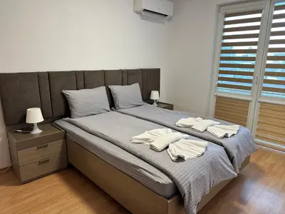 a bedroom with a bed with two towels on it at White Wood Lodge in Bansko