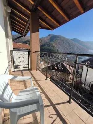 a balcony with a view of a mountain at Centaur Family Hotel in Rila