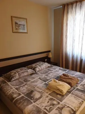a bed in a bedroom with a blanket on it at Dream Apart Hotel 207 in Bansko