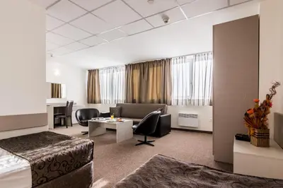 a hotel room with a bed and a desk at Park Hotel Moskva in Sofia