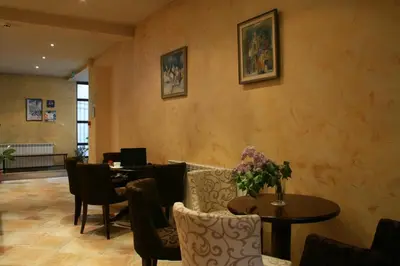 a dining room with a table and chairs and a table and a tablektop at Bizev Hotel in Bansko