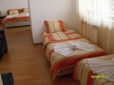 a hotel room with two beds with towels on them at Hotel Gazei in Bansko