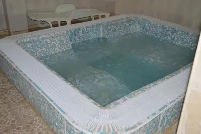 a large swimming pool in the middle of a room at Hotel Gazei in Bansko