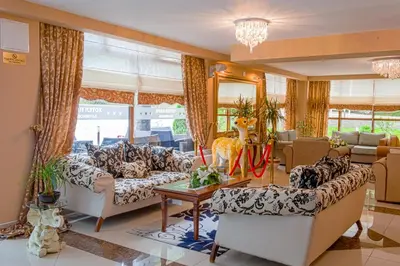 a living room with couches and a table at Hotel Park Bachinovo in Blagoevgrad