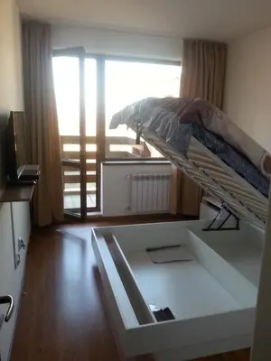 a bunk bed in a room with a window at Belveder Holiday Club Private in Bansko