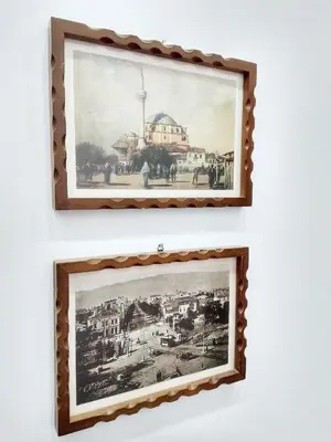 two framed pictures of a city on a wall at Ayki - historic centre apartment in Sofia
