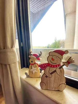 two stuffed teddy bears sitting on a window sill at Papa Moose Pamporovo in Pamporovo
