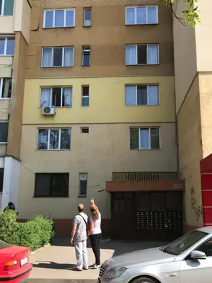 two people standing in front of a building at Modern Studio 20 Meters from Mladost 1 Metro Station in Sofia