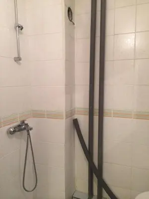 a shower with a hose in a bathroom at Modern Studio 20 Meters from Mladost 1 Metro Station in Sofia