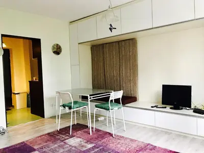 a dining room with a glass table and two chairs at Modern Studio 20 Meters from Mladost 1 Metro Station in Sofia