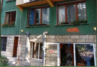a green building with a hotel written on it at Stivan Iskar Hotel in Sofia