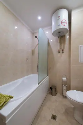 a bathroom with a bath tub and a toilet at City Apartments in Sofia