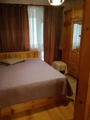 a bedroom with a wooden bed and a window at Apartment Beti in Devin