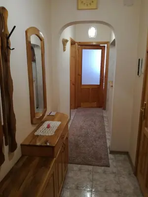 a bathroom with a wooden door and a mirror at Apartment Beti in Devin