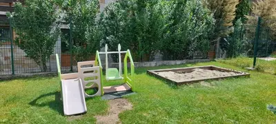 a playground with a slide in a yard at Katy's studio in Bansko