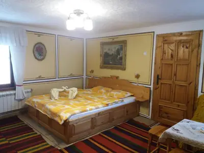 a bedroom with a bed with towels on it at Guest Rooms Bashtina Striaha in Koprivshtitsa
