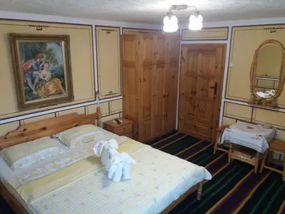 a bedroom with a bed with two stuffed animals on it at Guest Rooms Bashtina Striaha in Koprivshtitsa