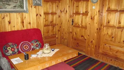 a living room with a couch and a table at Guest Rooms Bashtina Striaha in Koprivshtitsa