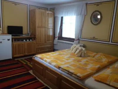 a bedroom with a large bed and a window at Guest Rooms Bashtina Striaha in Koprivshtitsa