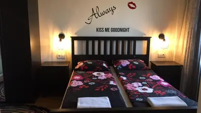 a bedroom with a bed with flowers on it at Panorama Apartment Darvenitsa in Sofia