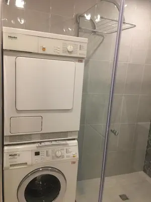 a washing machine and a washer in a bathroom at Panorama Apartment Darvenitsa in Sofia