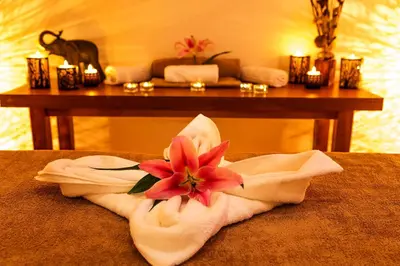 a towel with a flower on top of a room at Family Hotel Romantika in Velingrad