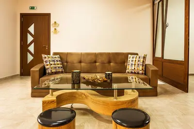 a living room with a couch and a glass table at Family Hotel Romantika in Velingrad