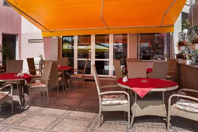 a restaurant with tables and chairs with red table cloth at Family Hotel Gerdjika in Plovdiv