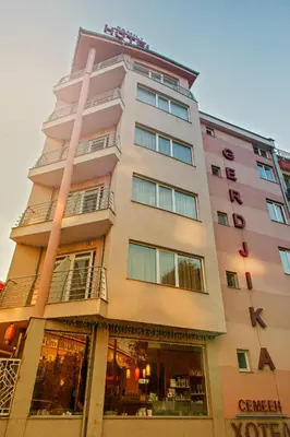 a tall building with a store front at Family Hotel Gerdjika in Plovdiv