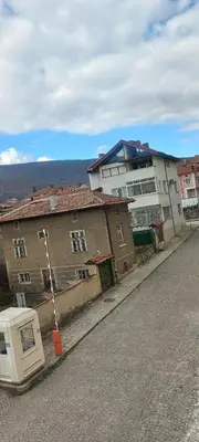 a street with two buildings and a house at Hotel Lago Peshtera in Peshtera