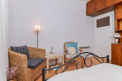 a bedroom with a bed and a chair and a table at Shik & Chic One Bedroom Central Apartment Graf Ignatiev x Shishman Corner by Flat Mаnager in Sofia