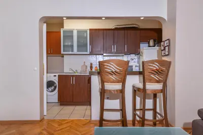 a kitchen with two chairs and a kitchen counter at Comfortable One Bedroom Apartment in a Lively Area | Zona B5 | Russian Square in Sofia
