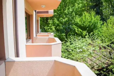 a balcony of a house with trees in the background at Комплекс Кремен in Blagoevgrad