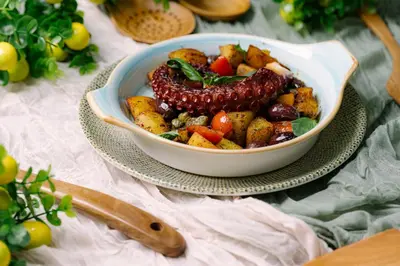 a bowl of food on a plate on a table at Комплекс Кремен in Blagoevgrad