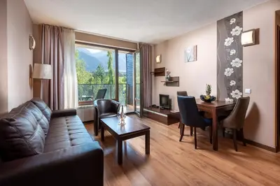 a living room with a couch and a table at Terra Hotel in Bansko