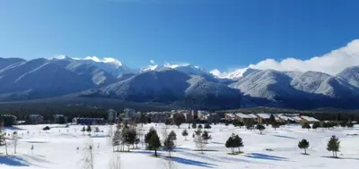 a view of a snowy mountain range with a city at Terra Hotel in Bansko