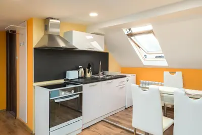 a kitchen with a sink and a stove top oven at Serdika Round Tower Apartments in Sofia