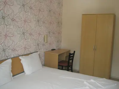 a bedroom with a bed and a desk with a chair at BLOCK 531 ApartHouse BLOCK 533 in Sofia
