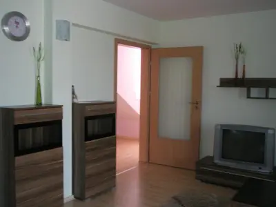 a living room with a door and a television at BLOCK 531 ApartHouse BLOCK 533 in Sofia