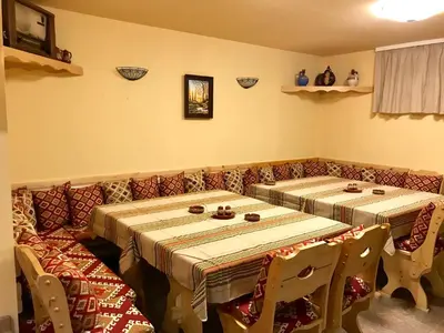 two long tables in a room with chairs at Vila Rila Samokov in Samokov