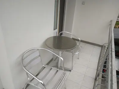 a table and two chairs sitting on a floor at Family Hotel Blazhi in Sandanski