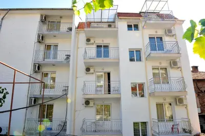 an apartment building with balconies and windows at Family Hotel Blazhi in Sandanski