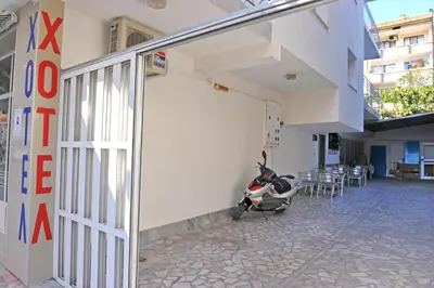 a scooter parked outside of a building next to a building at Family Hotel Blazhi in Sandanski