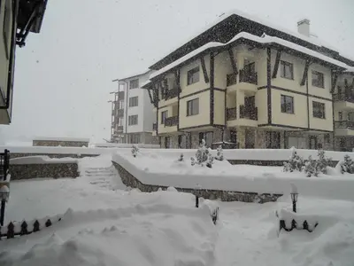 a house covered in snow in front at Maria-Antoaneta Residence in Bansko