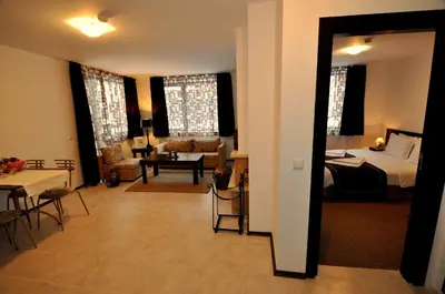 a bedroom with a bed and a living room at Maria-Antoaneta Residence in Bansko