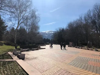 a group of people walking down a brick sidewalk at Center apartment with amazing view in Sofia