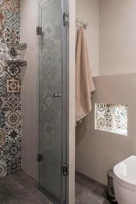 a shower with a glass door in a bathroom at Center apartment with amazing view in Sofia