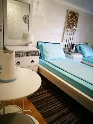a bedroom with a bed and a table and a table at Hotel Paradise in Sofia