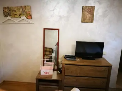 a dresser with a television and a mirror on it at Hotel Paradise in Sofia